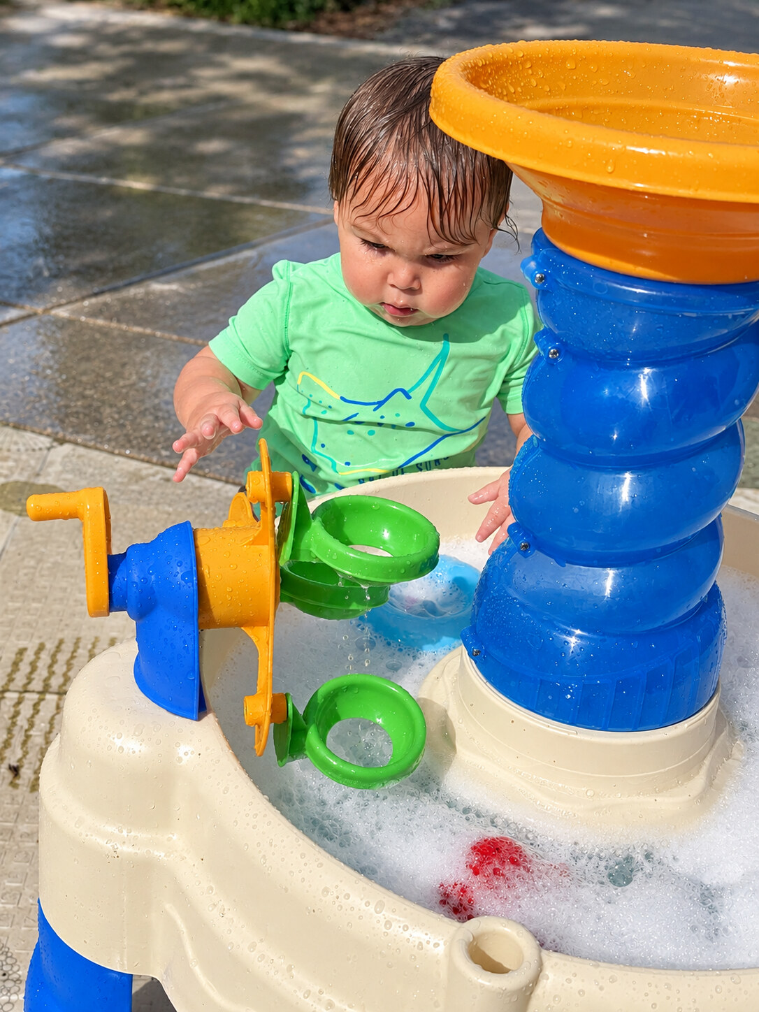 Young child exploring a water sensory table